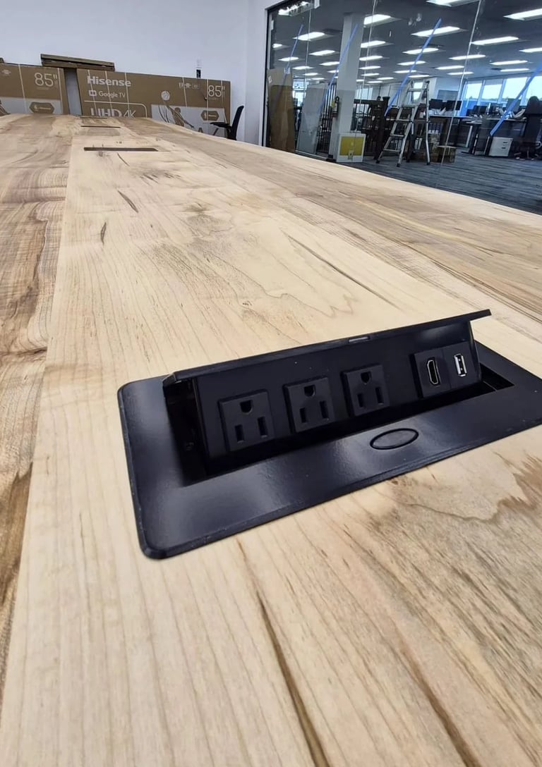 Integrated flush-mount power port in custom boardroom table — AC outlet, USB-A and USB-C