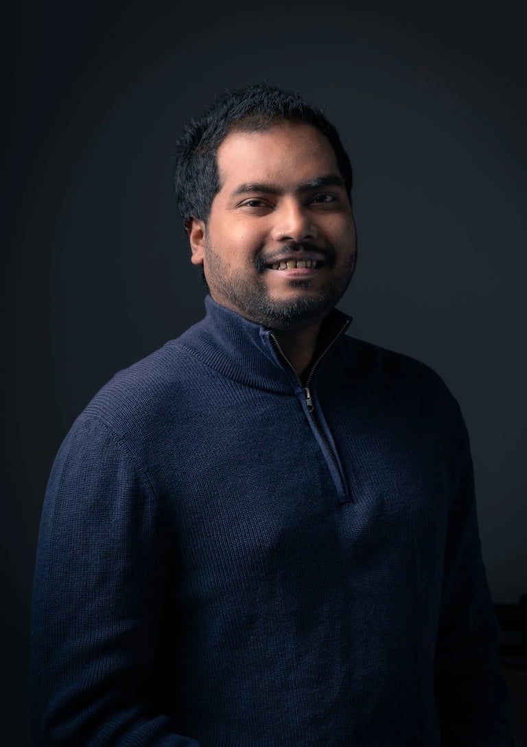 a man in a blue sweater in a dark background