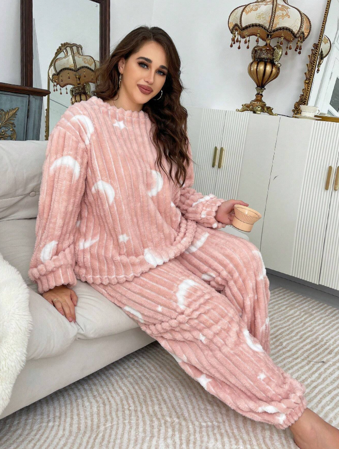 Stay warm and cozy in this soft plush pajama set with moon & star print