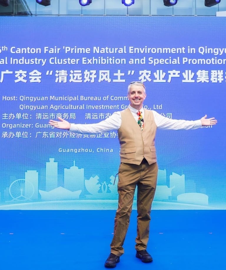 a man standing in front of a banner that says, the man is holding a