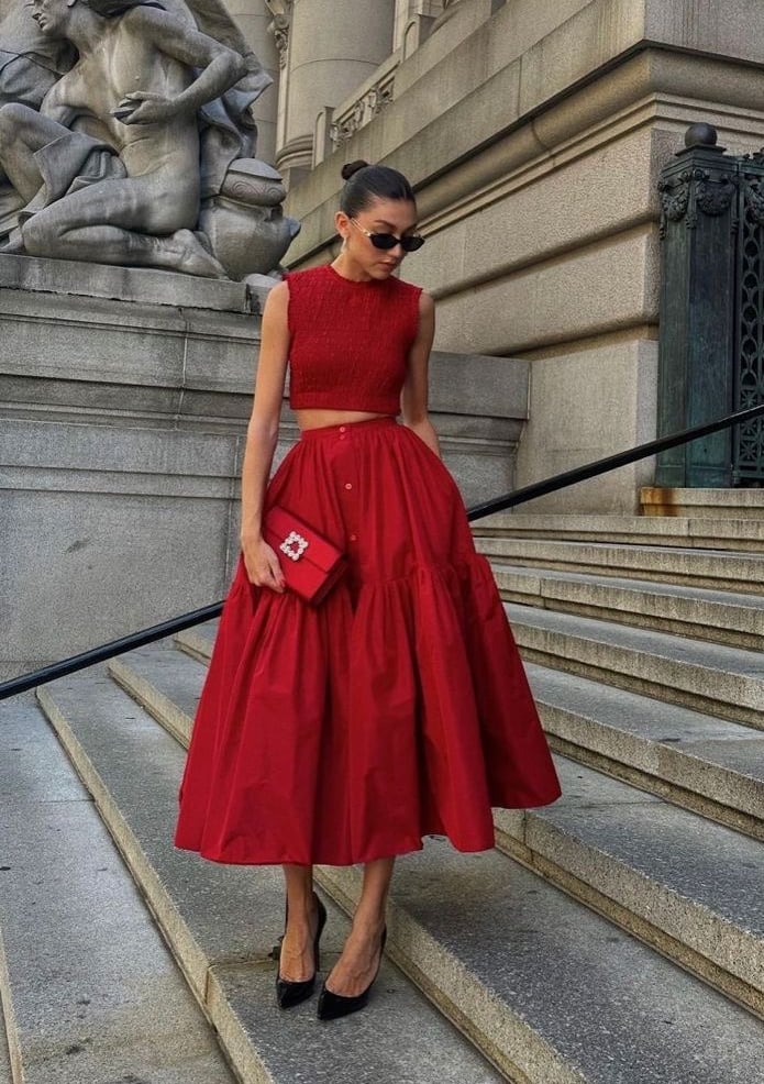 a woman in a red dress and sunglasses