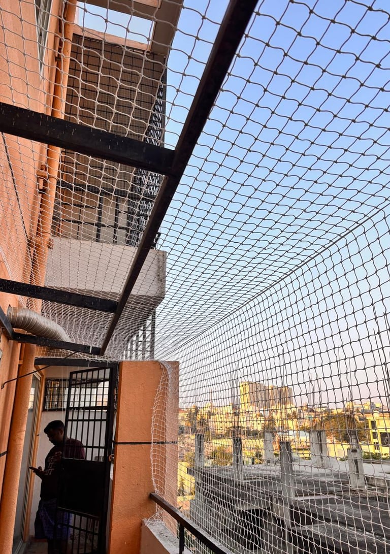 Close-up of a sturdy balcony pigeon net securely installed on a residential balcony in Vijayawada.