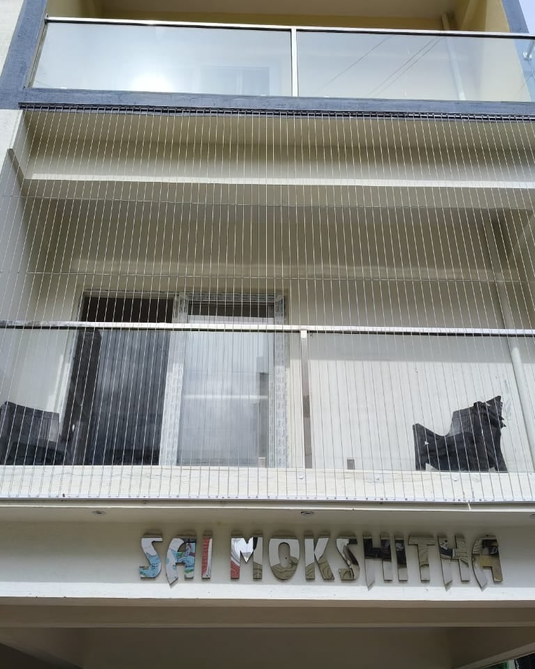 Close-up of a sleek invisible grill seamlessly blending with a Royapettah balcony.