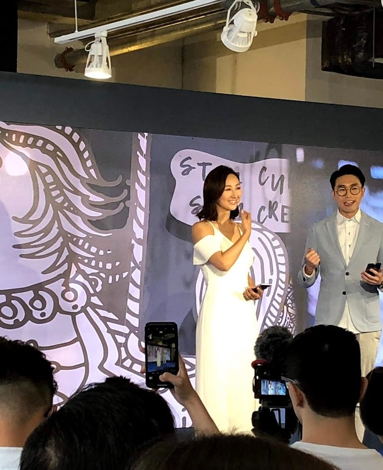 a man and woman standing on a stage