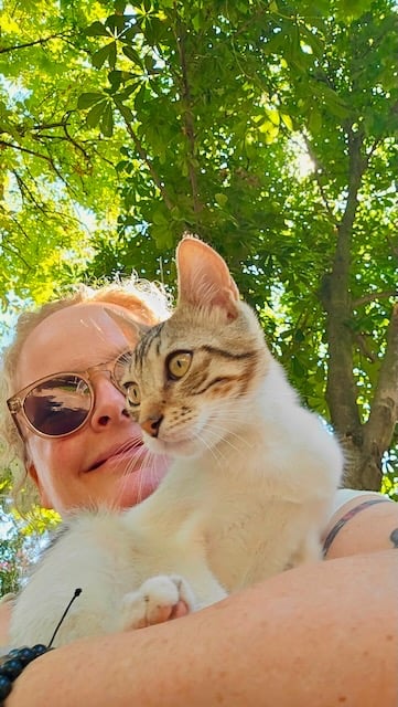 portrait of Sunni Dawson with kitten in park
