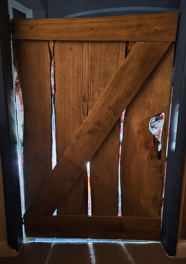 Bottom half of stable door made from resin and hard wood with sunlight shining through the resin.
