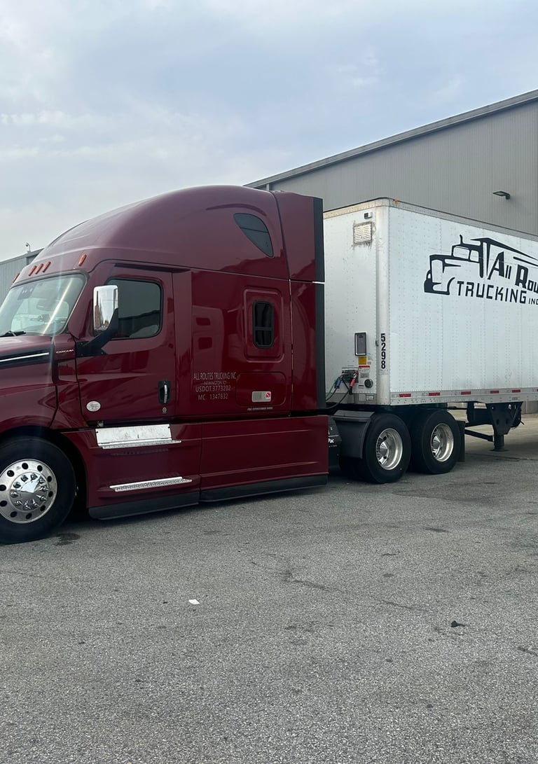 a semi truck with a trailer parked in front of a building