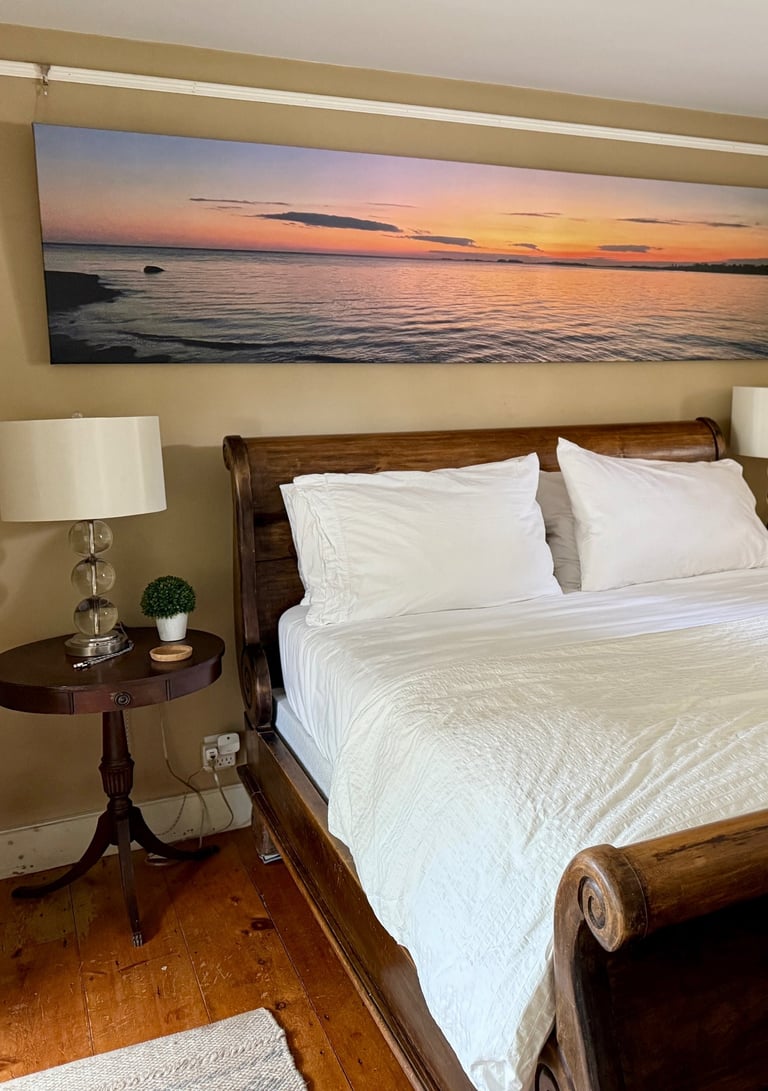 2nd ensuite bedroom with romantic sleigh bed and large-scale original canvas photography