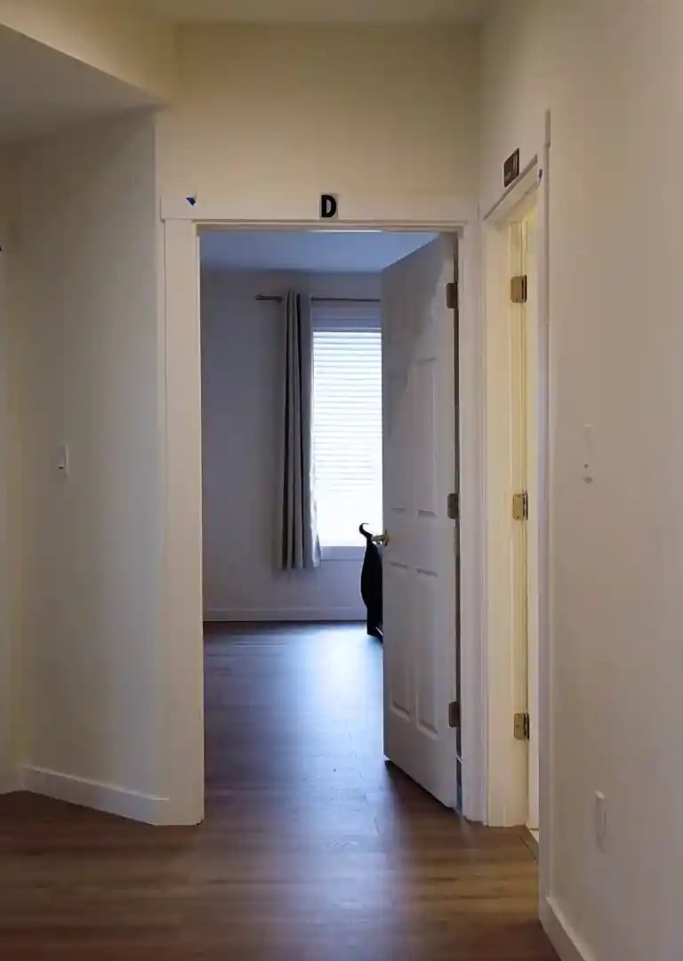 Private suites in adult family home with bed, seating area, and personal storage for resident comfort.