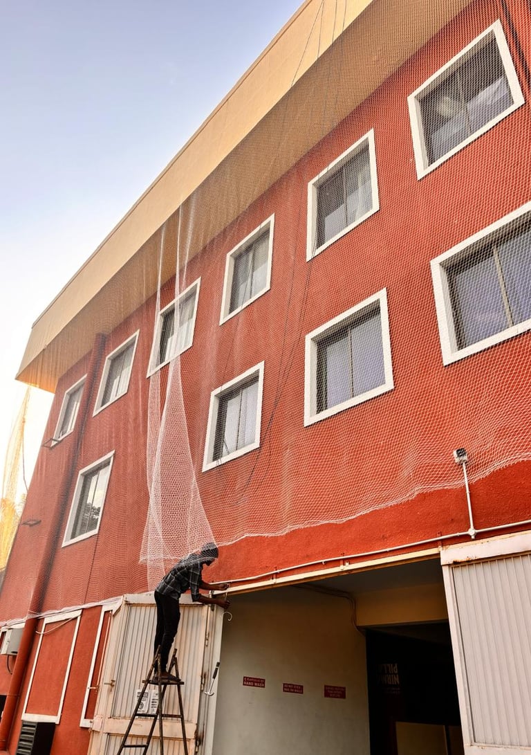 pigeon net perfectly installed on a balcony railing in Electronic City during sunset.