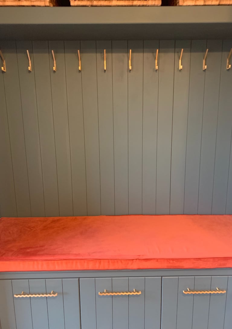 Bight orange velvet box cushion made to fit a coat stand. Plain fabric runs sideways to avoid joins