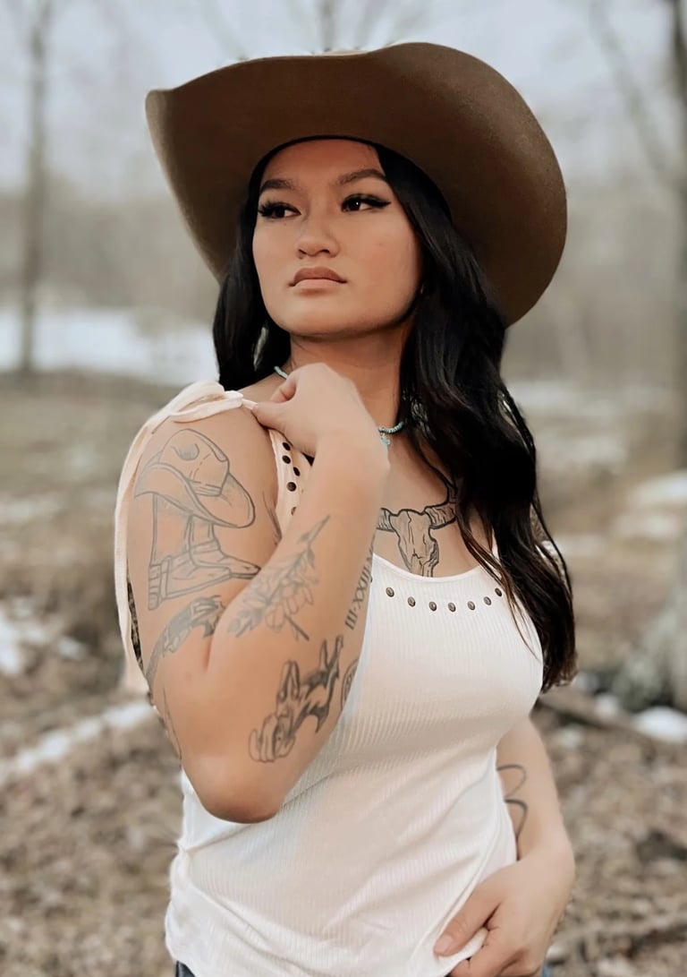 Amelia in a white top and tan cowboy hat