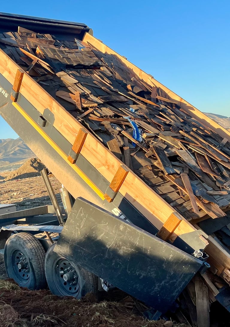 Roofing materials haul away and disposal in a dump trailer 