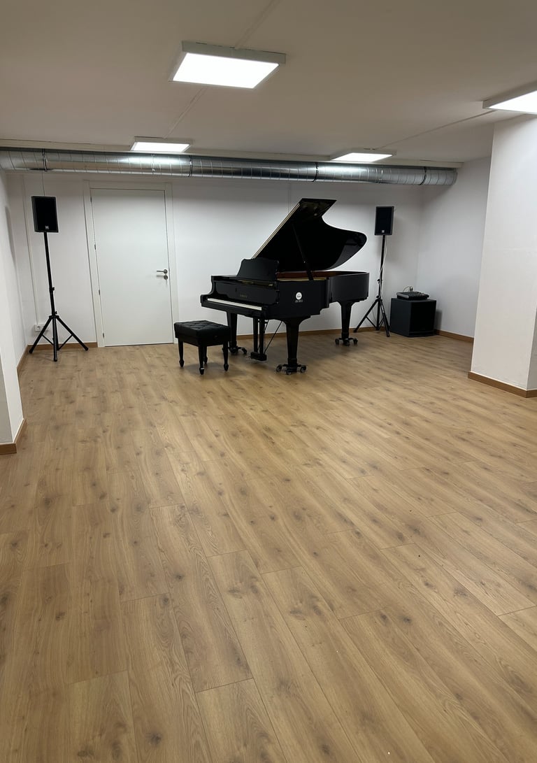 a piano player is in a big room with wood floor