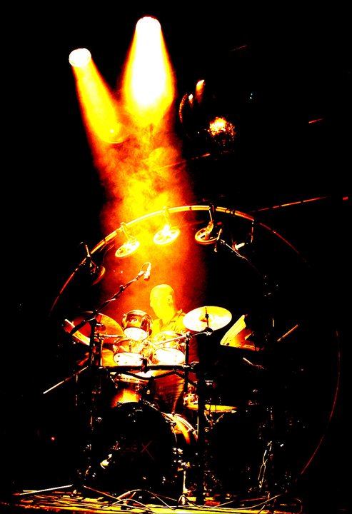 drum rig and drummer on stage with spotlight