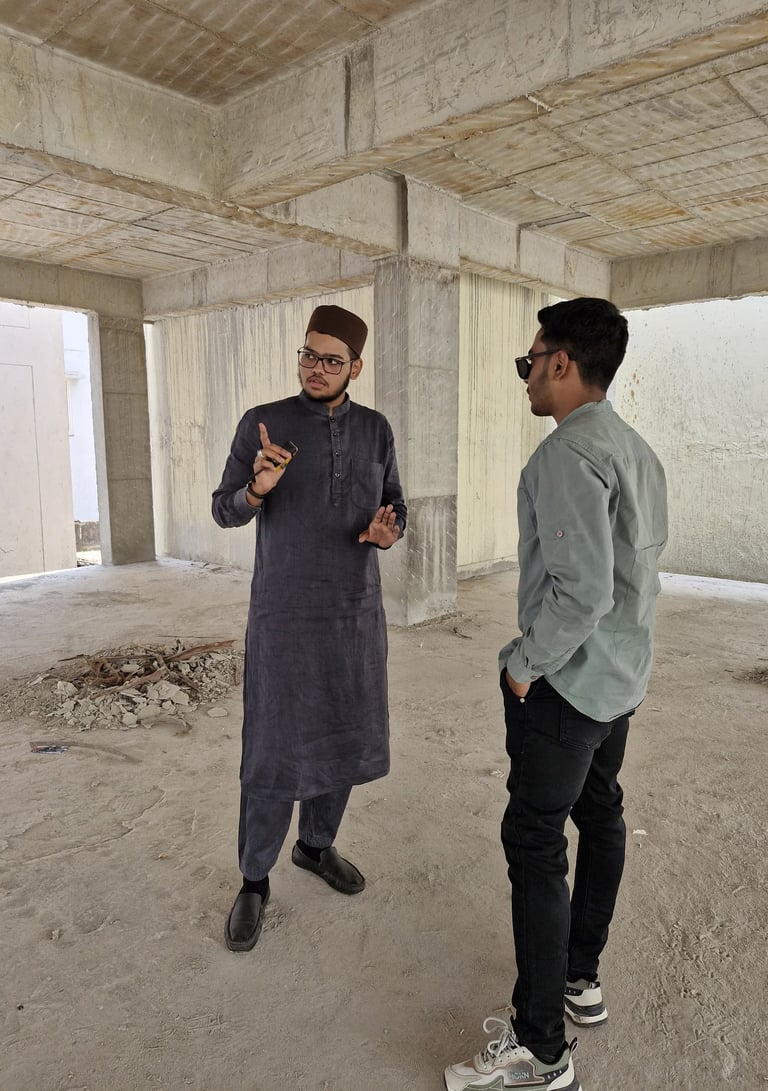 Engineer and architect in Hyderabad discussing construction plans with workers on-site, showcasing t