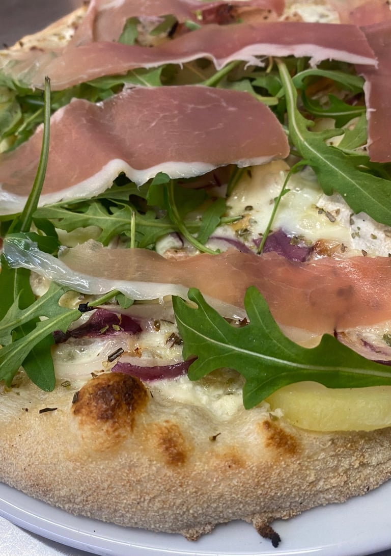 a pizza with cheese and vegetables on a plate