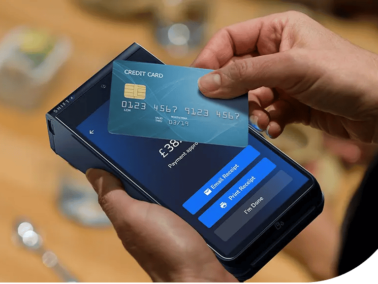 Customer using a contactless credit card for a mobile payment on a handheld POS terminal.