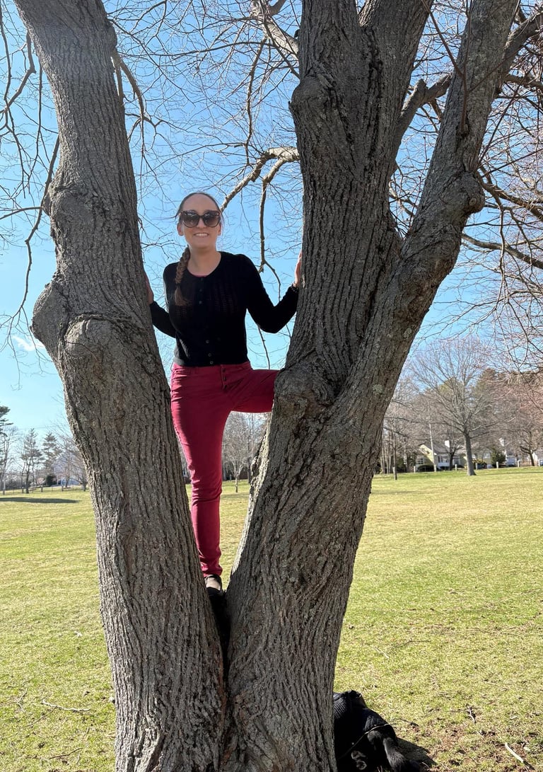 Zhenya climbs a tree. Caption: "Climbing toward your goals looks different for everyone!"