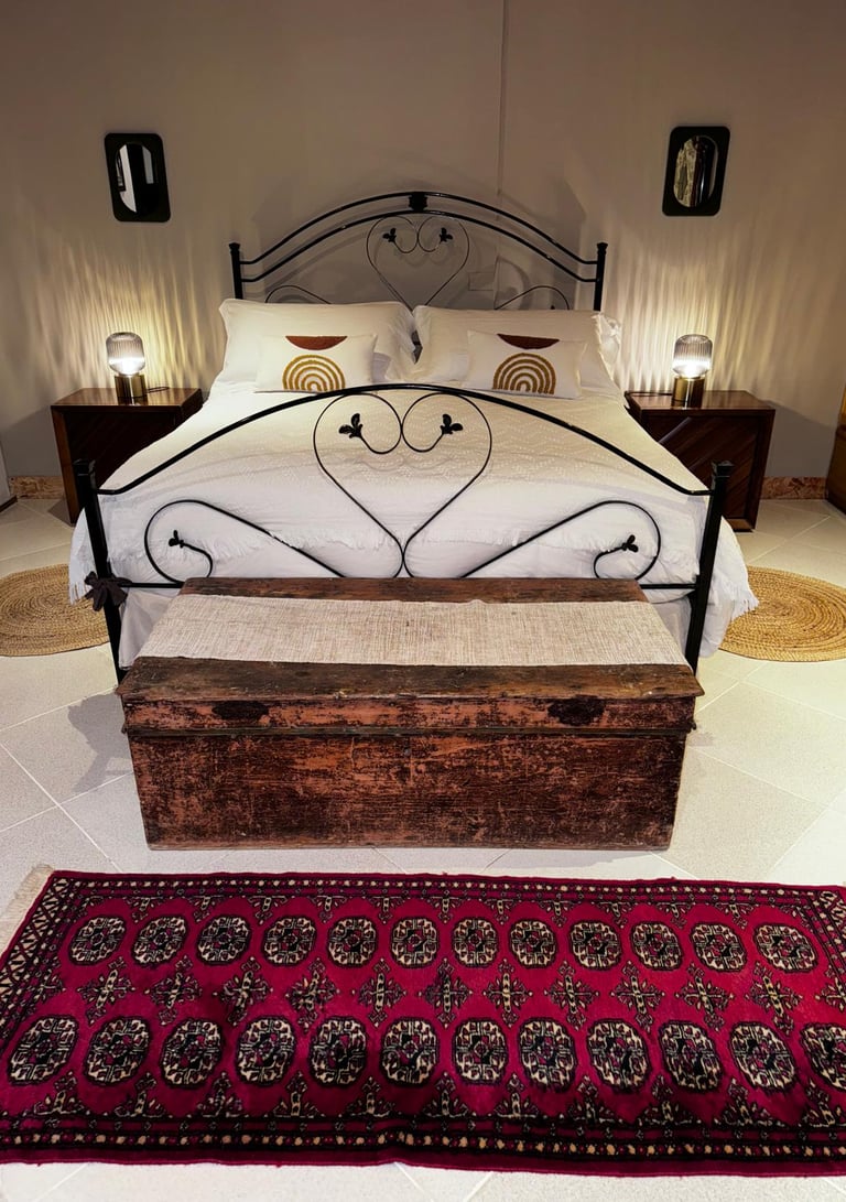 Elegant double bedroom in luxury villa in Siracusa, Sicily with rustic wooden chest