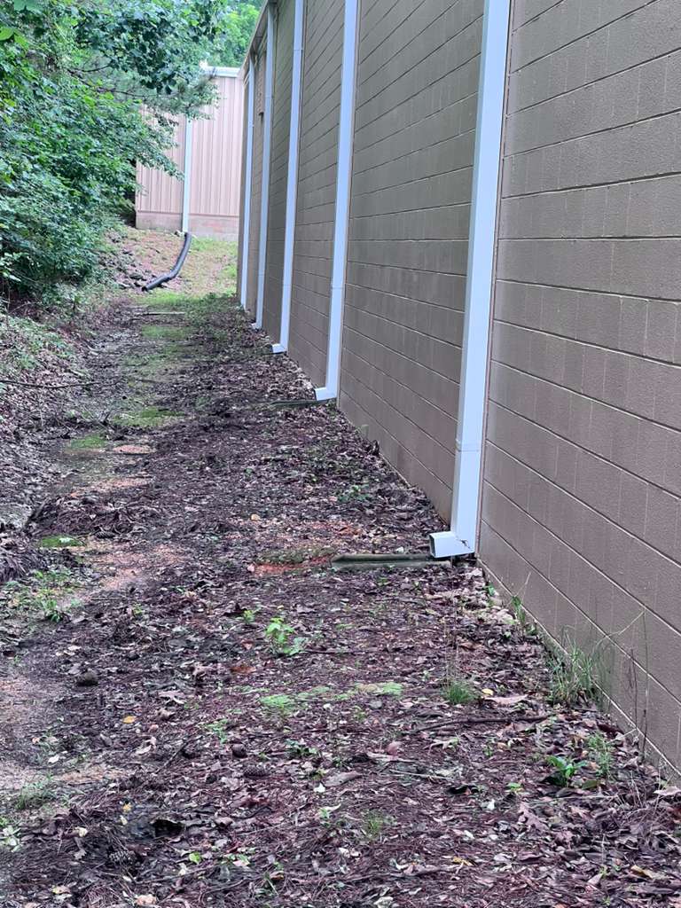 Front view of a house featuring a complete gutter and downspout system