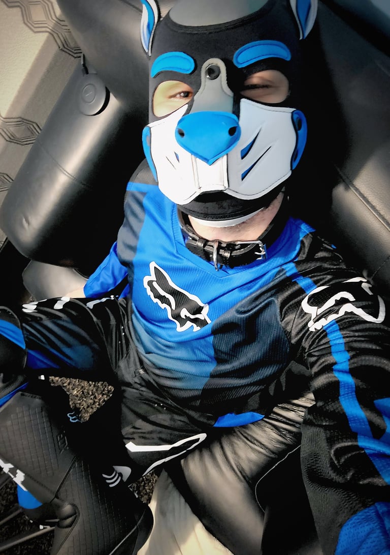 Pup in motorcycle suit and pup mask.