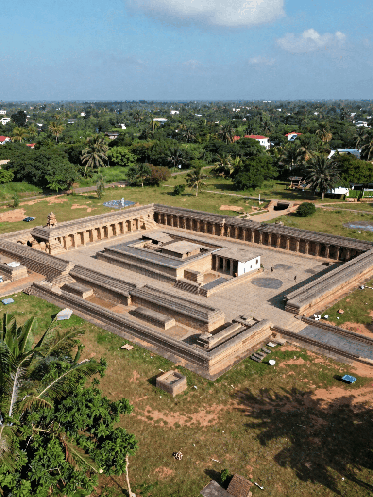 A vibrant gokart speeding around a sharp corner at GK Kart Kingdom in Keeladi, with lush greenery in the background.