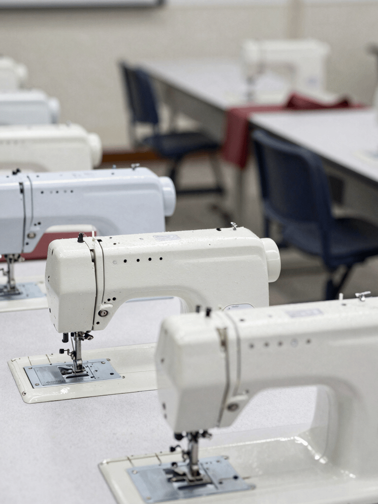 A vibrant group of students painting a large colorful mural together in the school art studio.