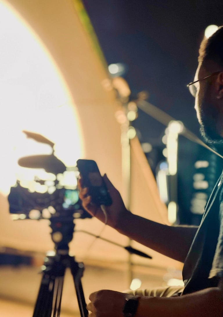 Daniel da Trindade filming behind the scenes on the set of a Patience Namadingo music video.