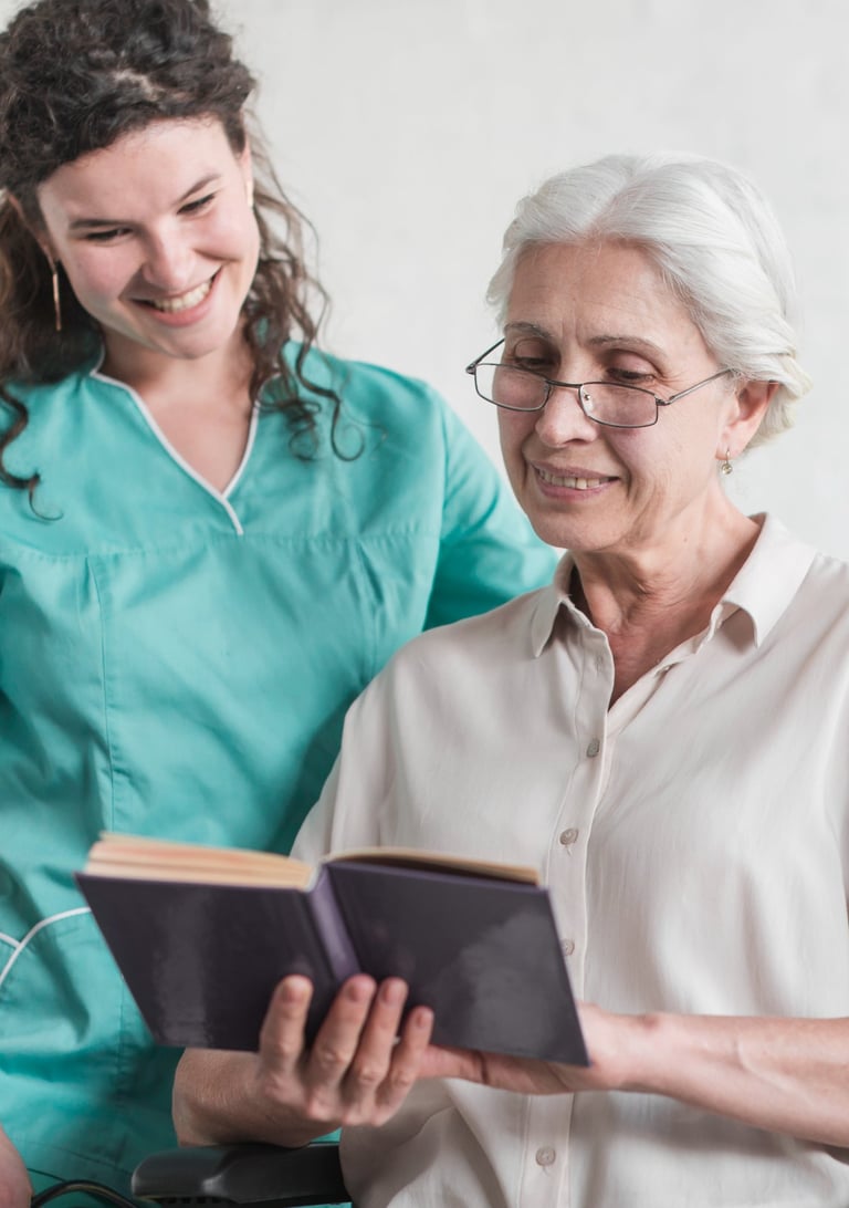 a senior woman reading a book with her caregiver