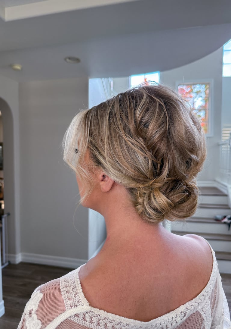 Lodi winery wedding featuring romantic low bun with face-framing tendrils