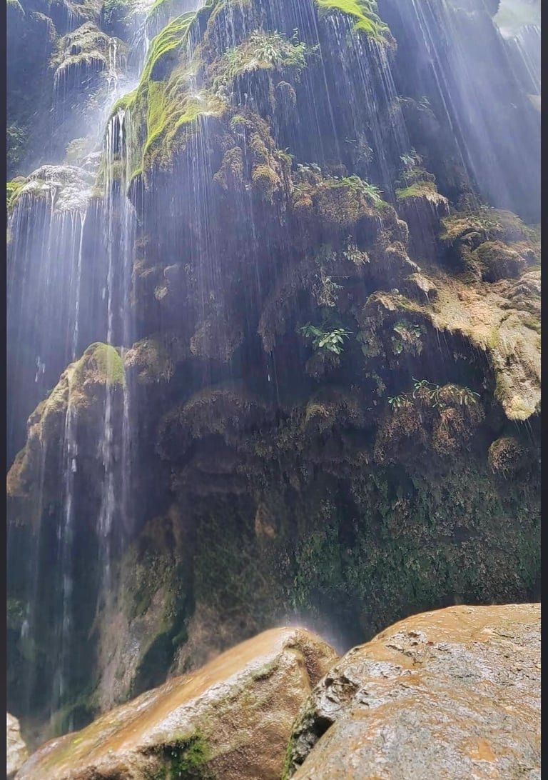 Umbrella waterfall in the middle of a mountain