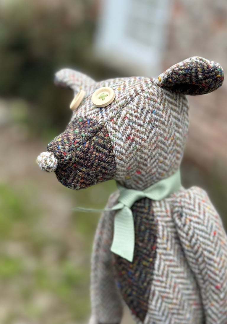 a teddy bear with a green bow tie