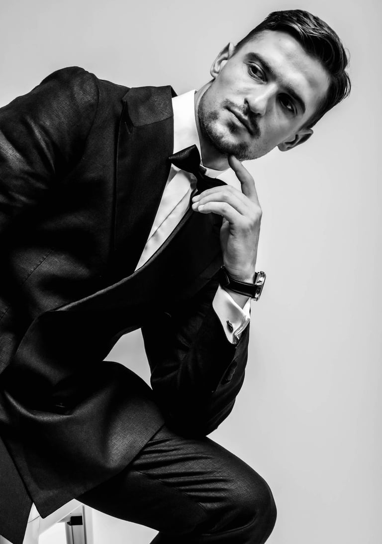 a man in a suit and tie is posing for a picture