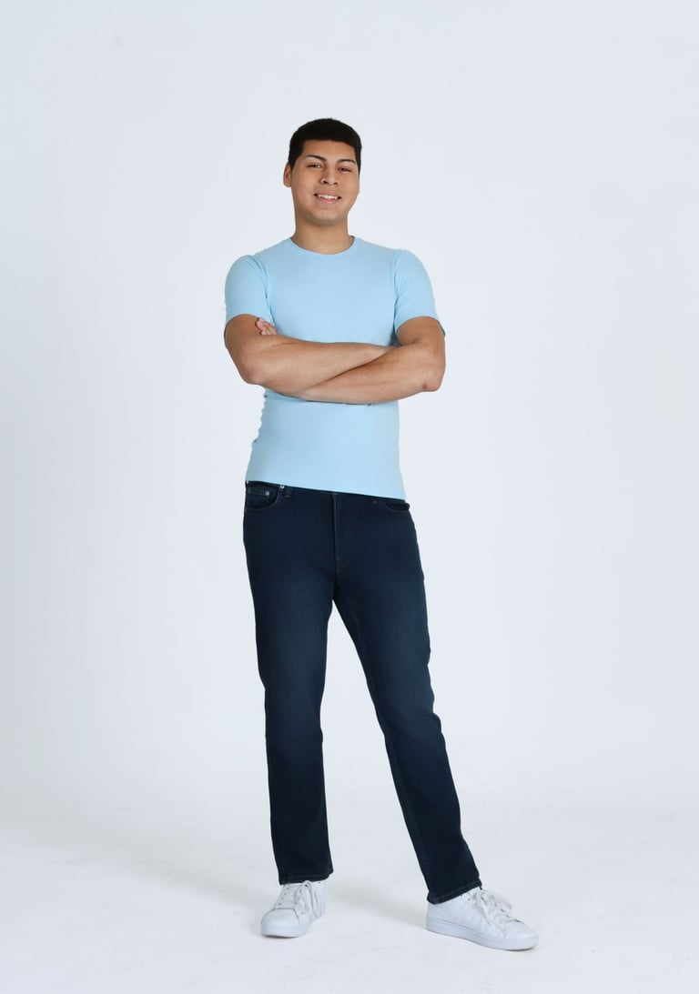 Issac Ellis full body portrait standing with arms crossed in studio