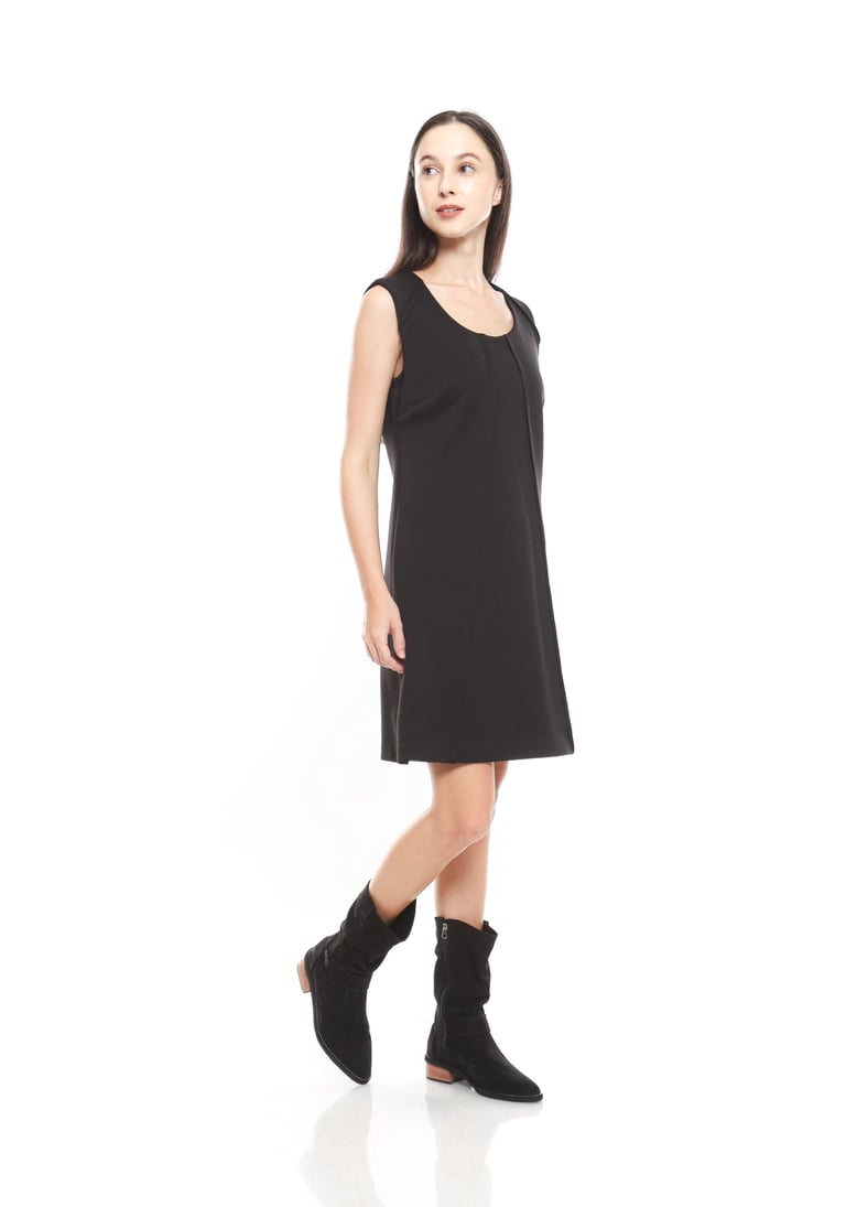 A woman wearing little back dress in black ankle boots
