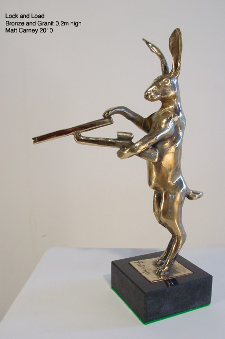 a statue of a rabbit with a gun in its hand
