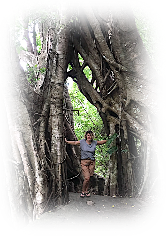 a woman standing in front of a tree