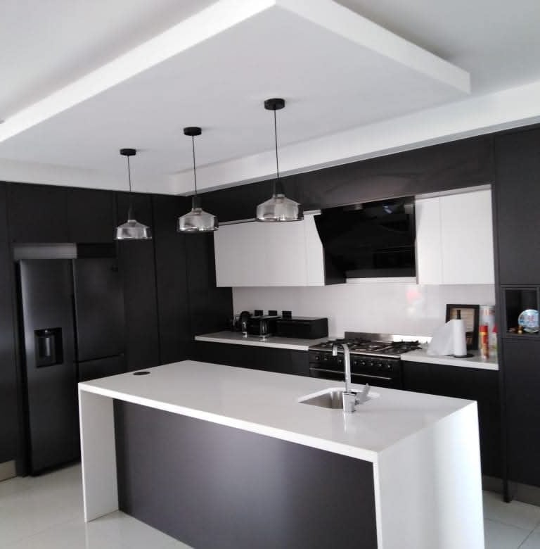 a kitchen with a refrigerator, refrigerator, and refrigerator freezer