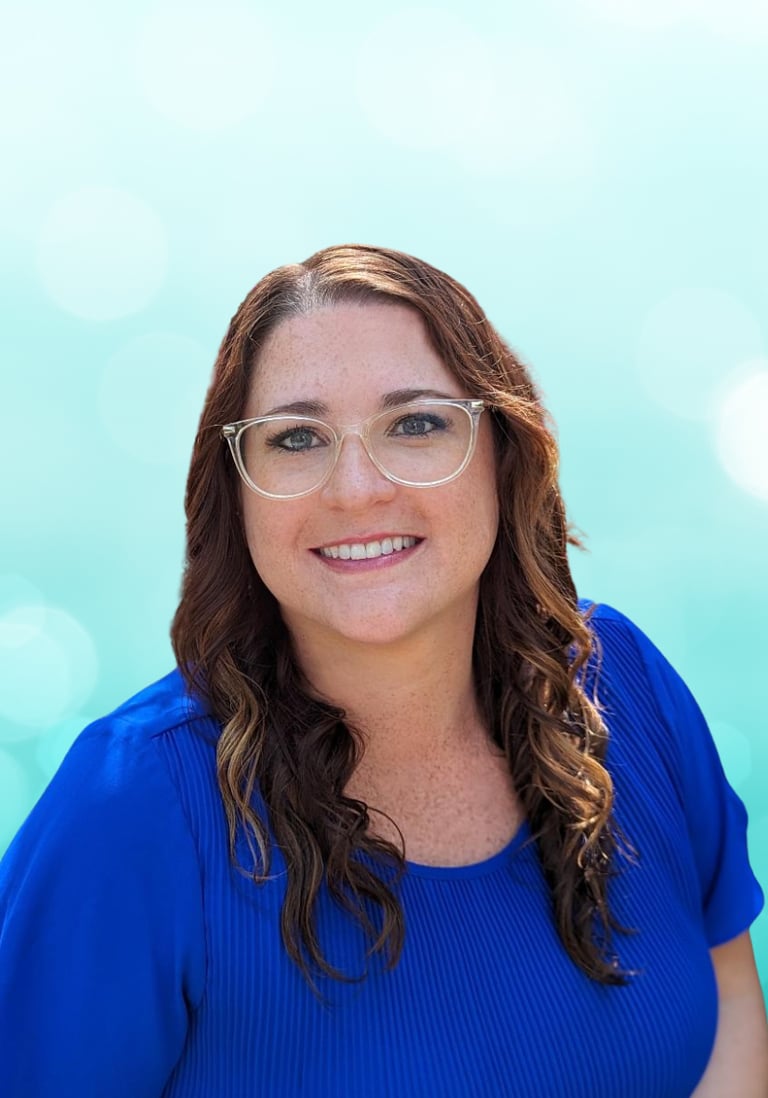 a woman in a blue shirt and glasses