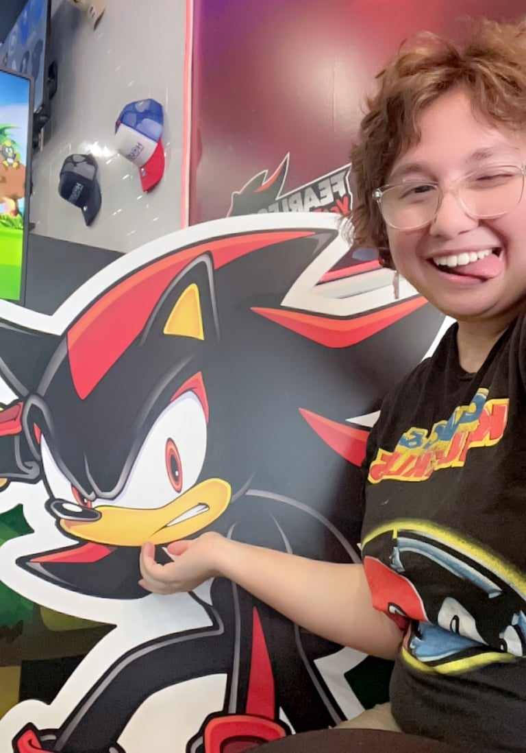 Maxine Rouge poses with her tongue out with Shadow the Hedgehog at the Sonic Speed Cafe in Katy, TX