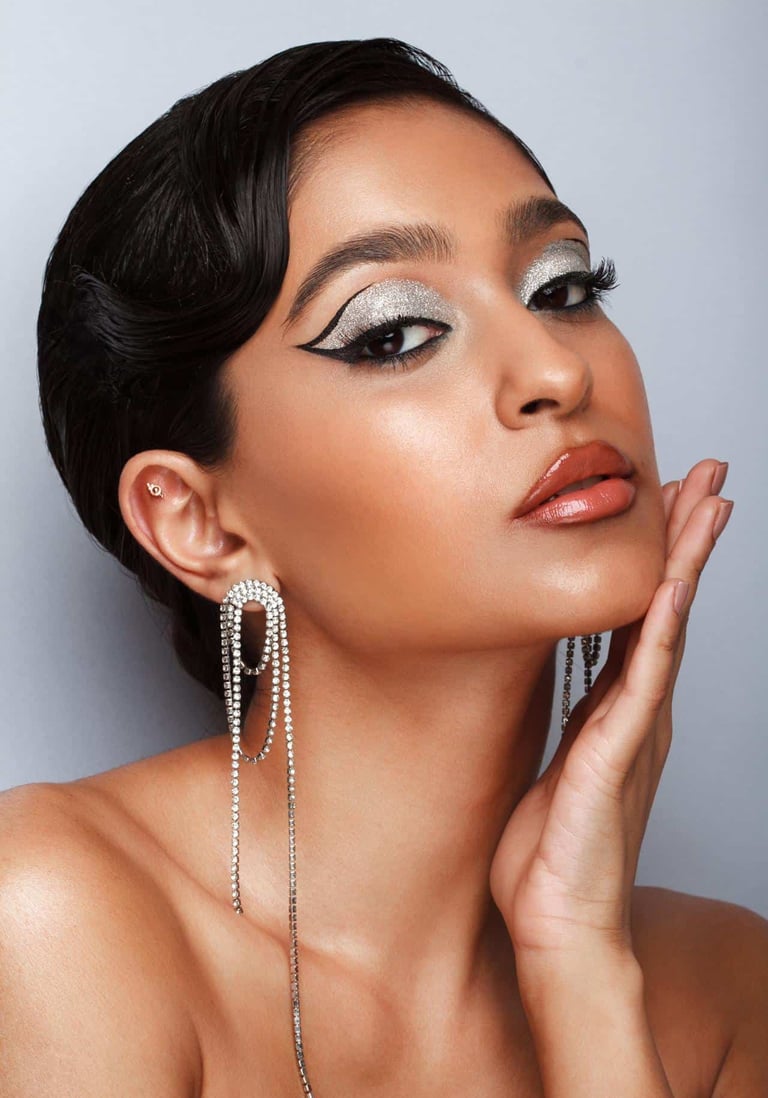 fashion portrait of makeup artist Zahra Omarji with glitter makeup