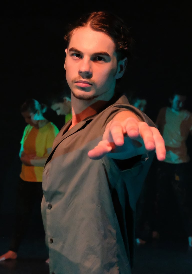 a man in a suit and tie is pointing at the camera