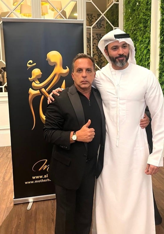 Bedig Minassian and a Sheikh, both in suits, pose together at an event