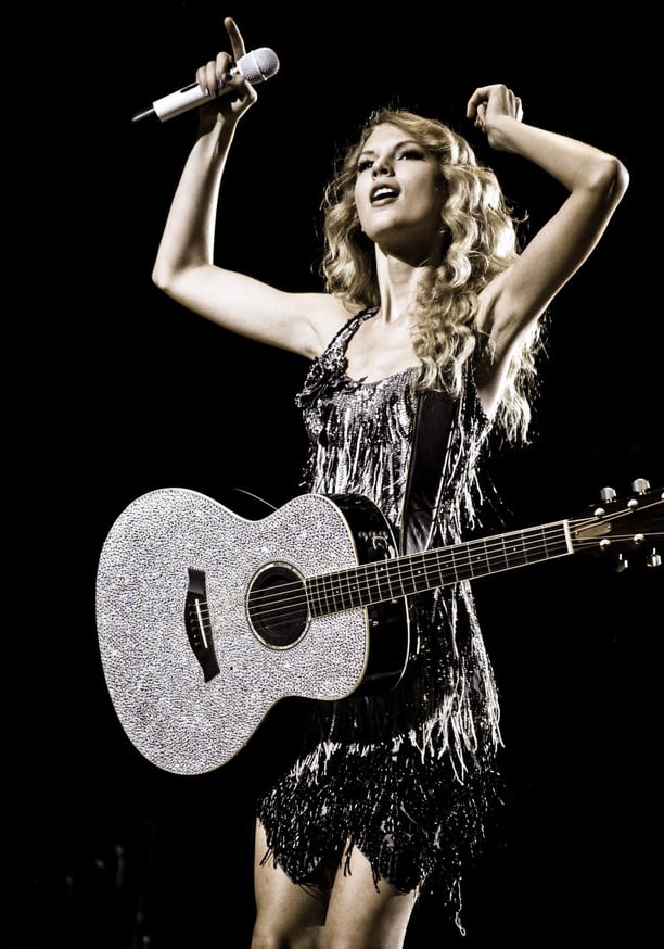 Taylor Swift performing with sparkly guitar at Fearless Tour 2009 concert in the USA.