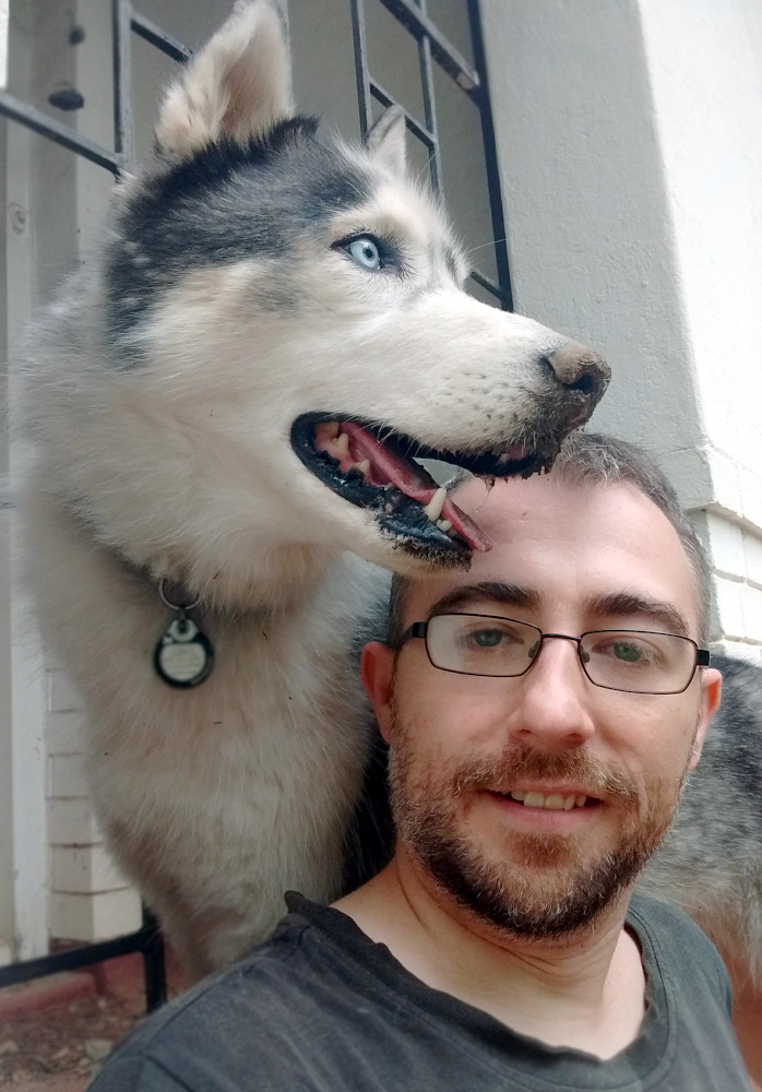the artist, Will, and his husky dog, Grail, pose for a selfie