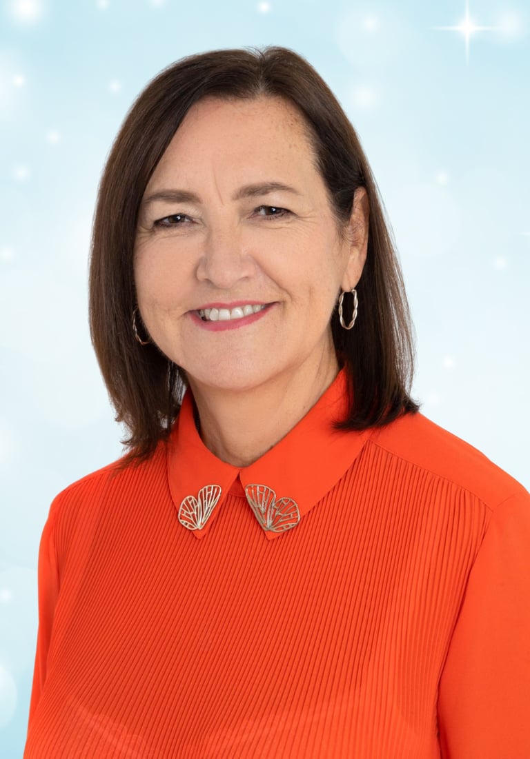 a woman in a red shirt and earrings