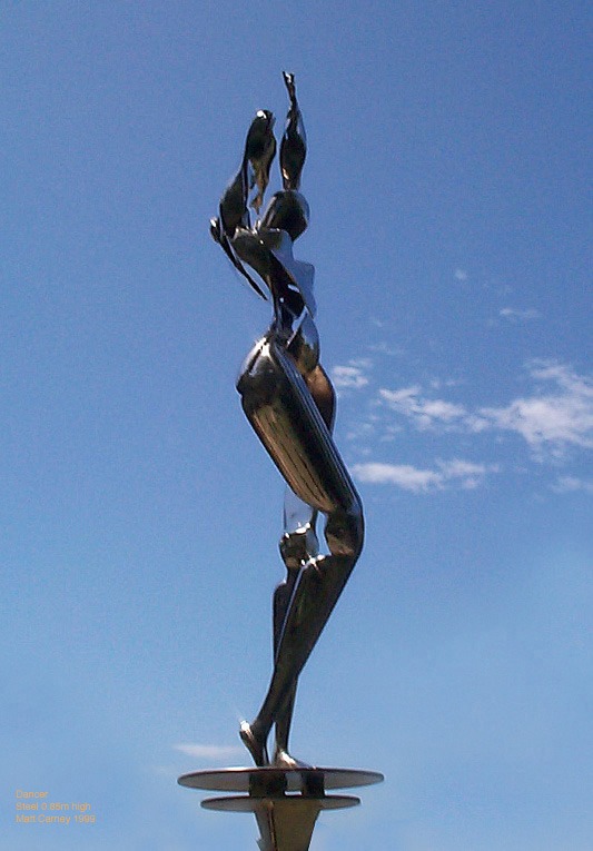 a chrome plated steel sculpture of a futuristic woman dancing on a pedestal
