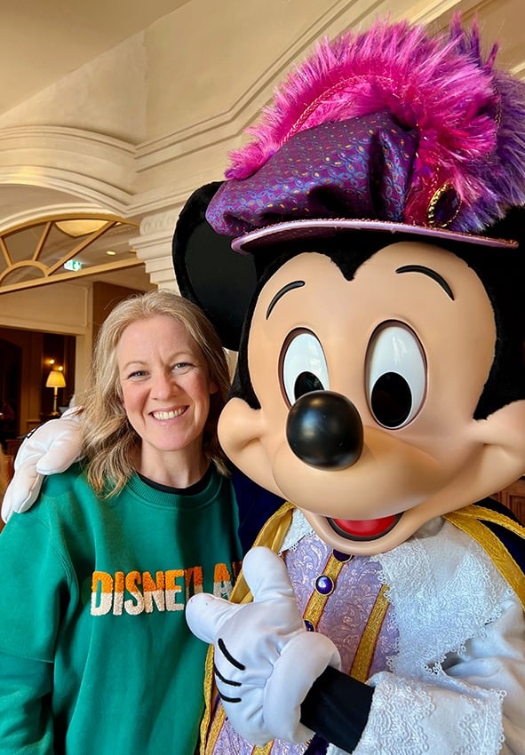 Leslie Hammer pictured with Mickey Mouse at Disneyland® Paris.
