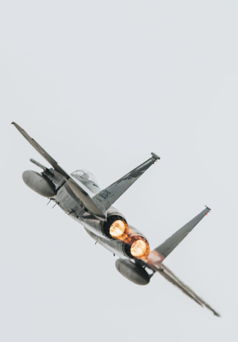 a fighter jet flying through the air f-16